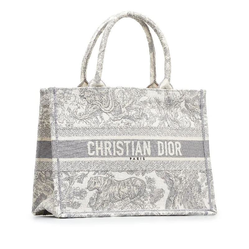 Christian Dior tote bags with a printed Dior logo on the frontDIOR Medium Toile de Jouy Book Tote Tote Bag